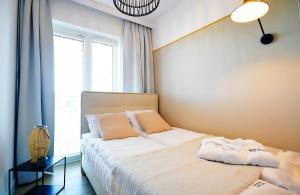 Postel nebo postele na pokoji v ubytování Apartments AQUA & SPA