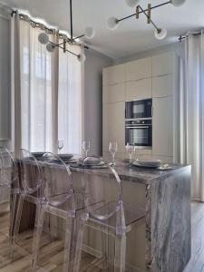 a dining room with a table with chairs and a kitchen at Central Park Apartments in Bjelovar