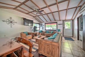 a living room with wooden furniture and a flat screen tv at Jamestown Retreat with Hot Tub - Walk to Lake! in Hartstown