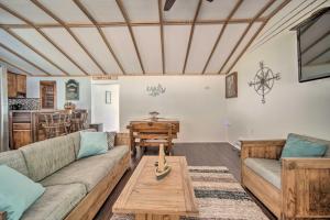 a living room with a couch and a table at Jamestown Retreat with Hot Tub - Walk to Lake! in Hartstown