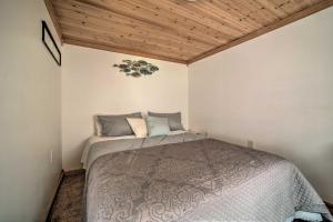 una camera con letto e soffitto in legno di Jamestown Retreat with Hot Tub - Walk to Lake! a Hartstown