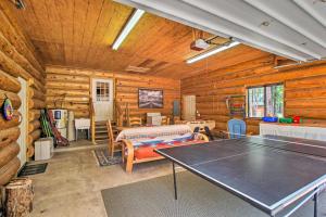 uma mesa de pingue-pongue num quarto com paredes de madeira em Tranquil Mountain Cabin with Game Room and Fireplace! em Greer