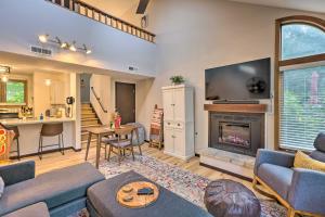 a living room with a tv and a fireplace at Family-Friendly Galena Townhome with Community Pools in Galena