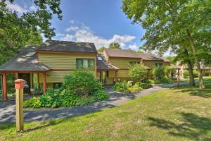 a yellow house with a driveway at Family-Friendly Galena Townhome with Community Pools in Galena