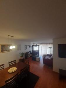 a living room with a table and a couch at Apartamento San Martin in Viña del Mar