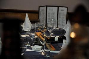 a table with glasses and a bottle of wine on it at Hotel Terex in Sarajevo