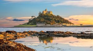 a castle on top of an island in the water at Finest Retreats - Poppy Cottage of Penzance in Penzance