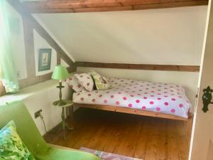 a small bedroom with a bed in a attic at St Michaels Coach House in Crediton