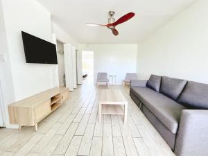 a living room with a couch and a flat screen tv at Tropi Rock in Fort Lauderdale