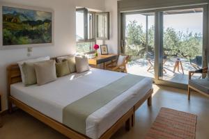 a bedroom with a large bed and a balcony at Zen Rocks Resort in Kalianeika