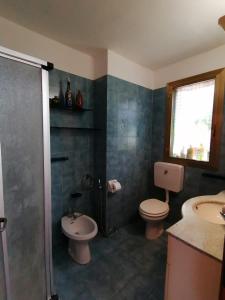 a bathroom with a shower and a toilet and a sink at Appartamento Tra Le Torri in Noli