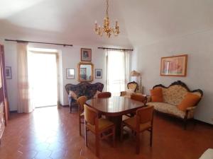 a living room with a table and chairs at Appartamento Tra Le Torri in Noli +23 photos