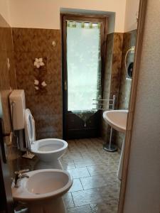 a bathroom with a toilet and a sink at Alloggi Il Rododendro in Bagni di Vinadio +24 photos