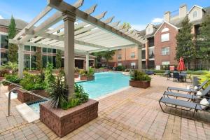 a pergola over a swimming pool at a hotel at Uptown Escape - Modern, 1BD Apt near the Galleria in Houston