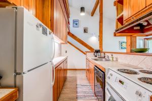 a kitchen with white appliances and wooden cabinets at Lake Creek 1323 in Wilson