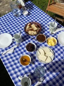 a blue and white checkered table with food on it at Guesthouse Mehmeti in Valbonë