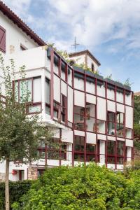 a white building with a cross on top of it at Auberge hiribarren in Biriatou