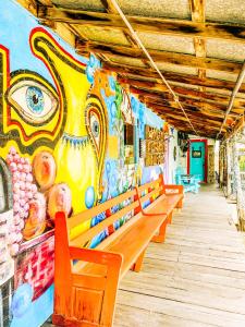 a row of benches in front of a wall with a mural at Inn at the Art Center in San Angelo