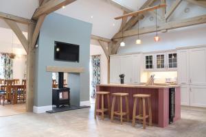 a kitchen with a bar and a stove at The Anchorage Nables Farm in Chippenham