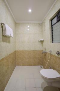 a bathroom with a toilet and a shower at StayBird - AERITH STUDIOS, Exclusive Residences, Kharadi in Pune