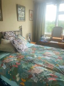 a bedroom with a large bed with a colorful blanket at Twenty in Lincolnshire