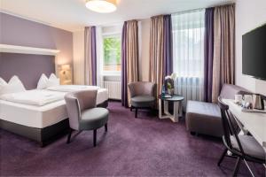Postel nebo postele na pokoji v ubytování Flair Hotel Rieckmann + 32 fotografií