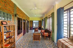 a living room with a couch and a chair at Silk Island Homestay 