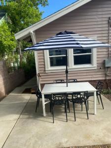 a table and two chairs with an umbrella at Downtown Williams, walk everywhere, remodeled in Williams
