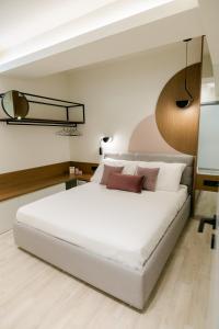 a bedroom with a large white bed and a basketball hoop at Magico Suites City Heart Luxury Appartments in Alexandroupoli