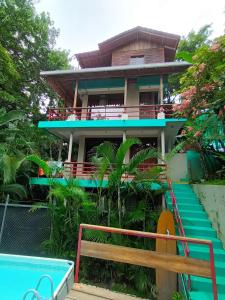 a house with a pool in front of it at Burnt Toast Surfcamp in Nosara