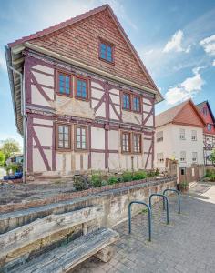 a house with a bench in front of it at Ferienhaus Christina in Reichensachsen