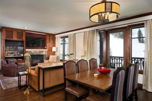 a dining room with a table and chairs and a living room at Aspen Ritz-carlton 2 Bedroom in Aspen