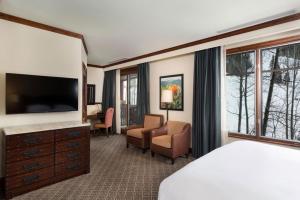 a hotel room with a bed and a television at Aspen Ritz-carlton 2 Bedroom in Aspen