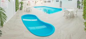 a swimming pool with a blue slide in a room at Hamburgo Palace Hotel in Balneário Camboriú