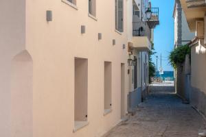 an alley way between buildings in a city at OLYMPIA ROOMS in Myrina