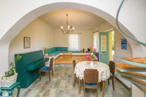 a dining room with an archway and a table and chairs at Villa Orion - Peaceful Retreat Home West of Chania in Kipárissos