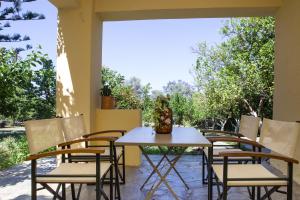 a table and chairs on a patio at Villa Orion - Peaceful Retreat Home West of Chania in Kipárissos