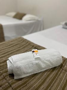 a towel is sitting on top of a bed at Center 1 Hotel in Fortaleza