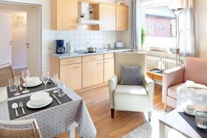 a kitchen and living room with a table and chairs at Hygge in List