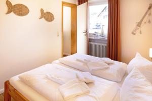 two beds in a room with towels on them at Hygge in List