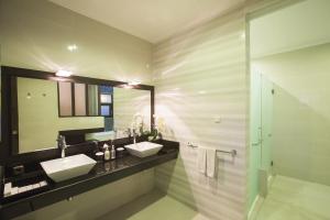 a bathroom with two sinks and a mirror at Flamingo Dewata Suite in Uluwatu +38 photos