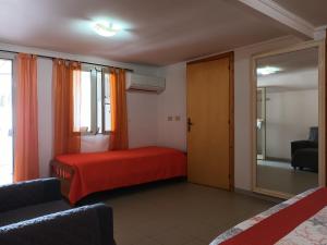 a bedroom with a red bed and a mirror at Mare e relax in Tropea
