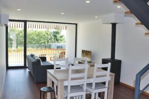 a living room with a table and chairs and a couch at Casa João Eusébio 3 in Ponte de Lima