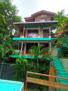 a house with a staircase in front of it at 1 Bedroom G-Land Burnt Toast Surfcamp in Nosara