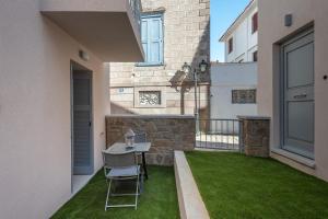 a small yard with a table and chairs on a balcony at OLYMPIA ROOMS in Myrina