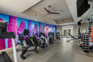 a gym with treadmills and elliptical machines at The Paloma Resort in Palm Springs