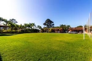 a large grassy field with a soccer ball at Pousada Recanto das Flores in Governador Celso Ramos