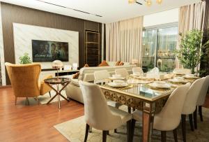 a dining room with a table and chairs at Luxury 3 BR - Direct View to Burj Khalifa in Dubai