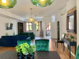 a living room with a blue couch and chairs at Apartamenty Krasicki in Lidzbark Warmiński