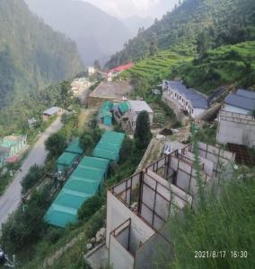 a view of a village on a mountain at Kedar Heights Heli Resorts by StayApart in Phata